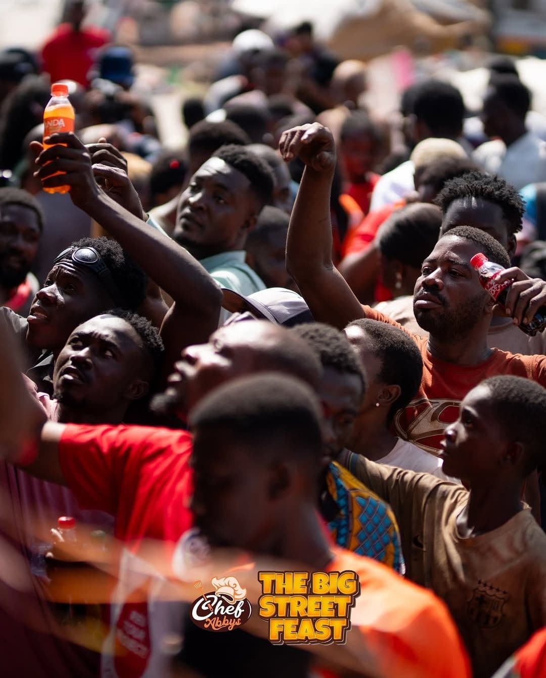Hands reaching for free food from the crowd
