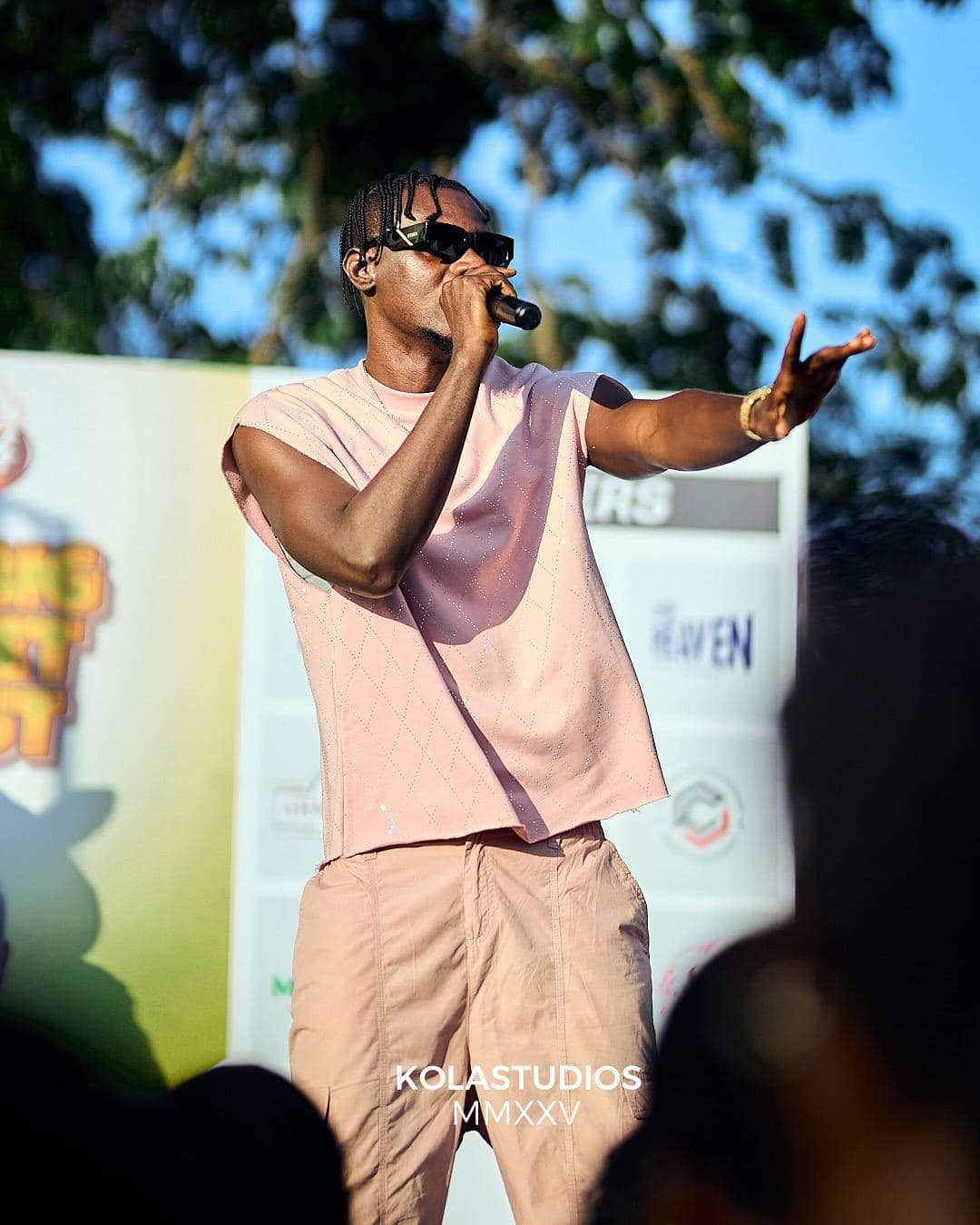 A performer on stage in front of the partners wall