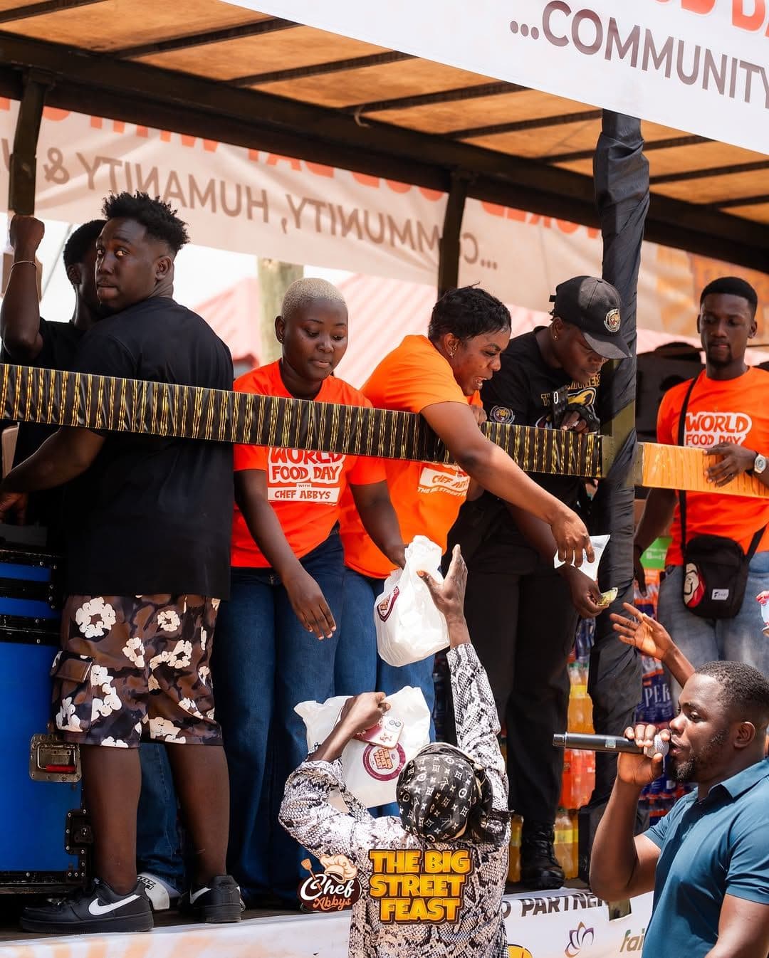 The serving team on the food truck with the crowd below