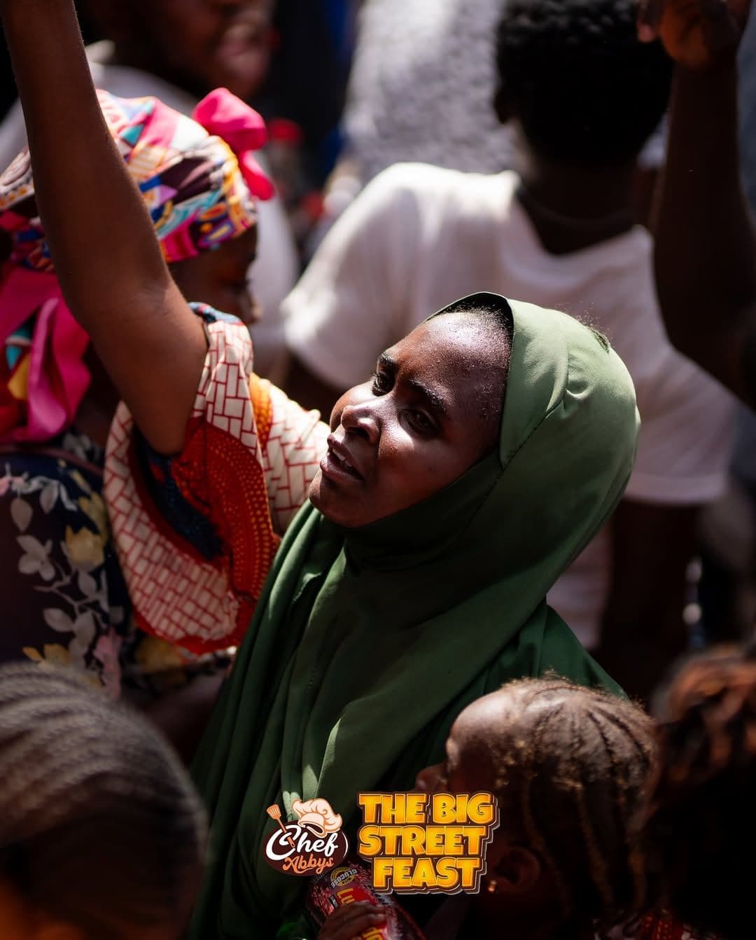 A young woman smiling as she receives her food