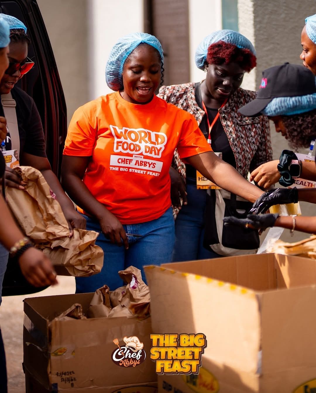 Chef Abby and volunteers packing food